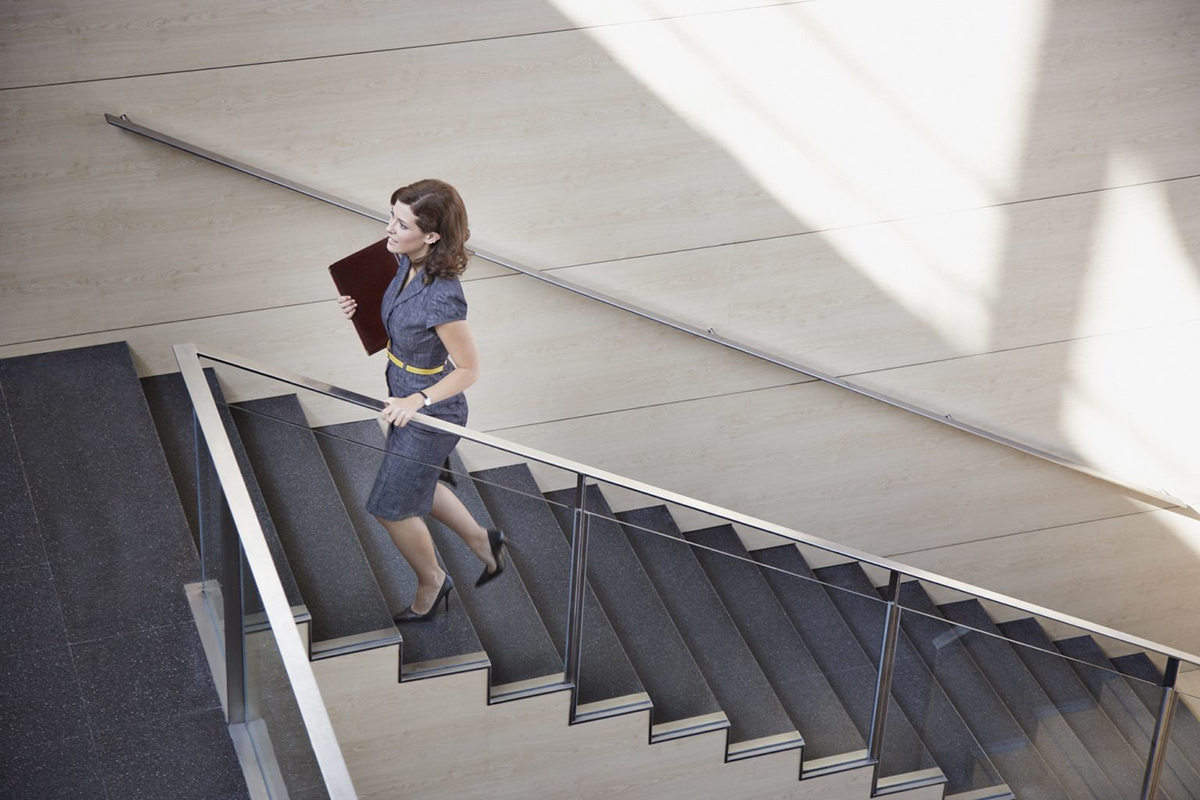 Image of a woman walking up a staircase